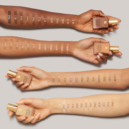 Four arms displaying various foundation shade swatches with bottles.