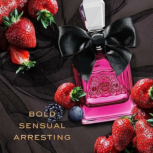 Pink perfume bottle with black bow surrounded by strawberries and berries.