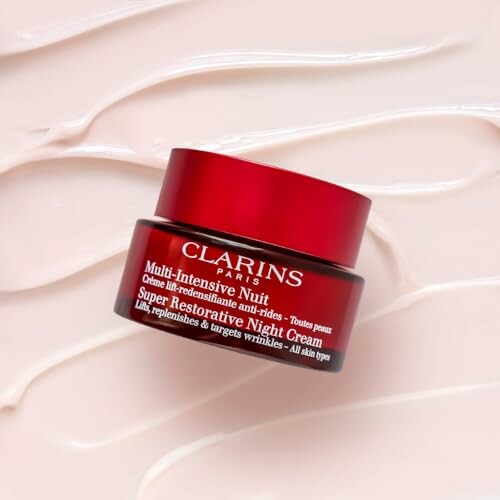 Clarins Super Restorative Night Cream on textured background