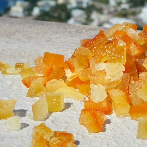 Pile of diced candied citrus peel on a stone surface.