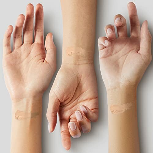 Three hands displaying different foundation swatches on wrists.