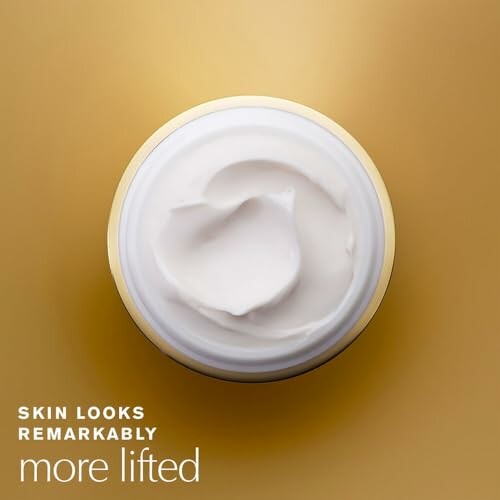 Top view of a jar of face cream on a gold background with text 'Skin looks remarkably more lifted'.