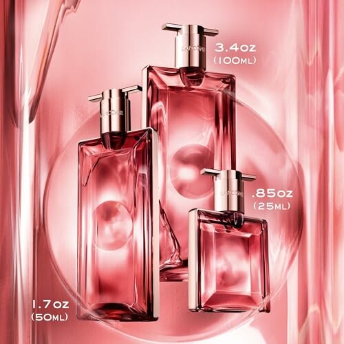 Three Lancome Idole perfume bottles in varying sizes.