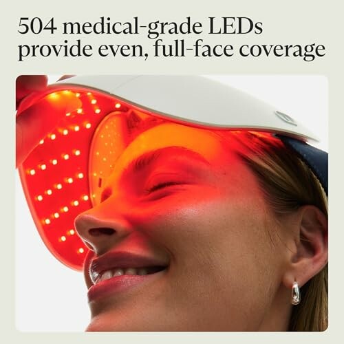 Woman using LED light therapy mask with red light