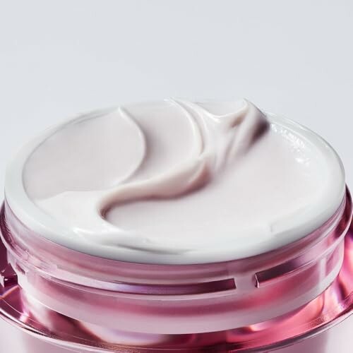 Open jar of luxury face cream with smooth texture