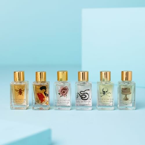 Six decorative perfume bottles on a blue background.