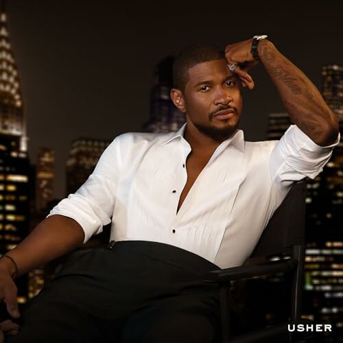 Man in white shirt sitting with city skyline in background.