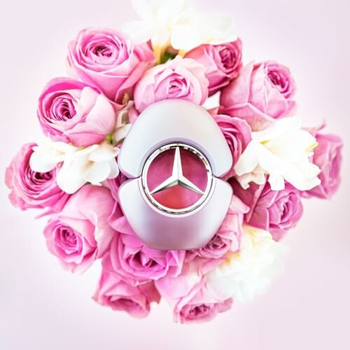 Mercedes perfume bottle surrounded by pink roses