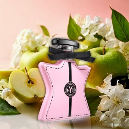 Pink perfume bottle with apples and flowers.