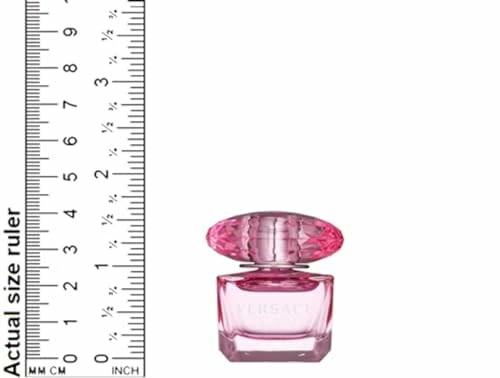 Small pink perfume bottle next to a size ruler.