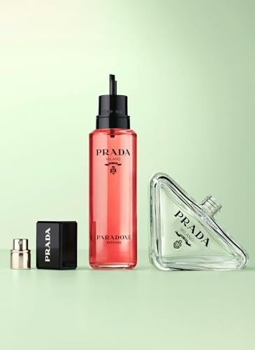 Prada Paradox perfume bottles on a green background