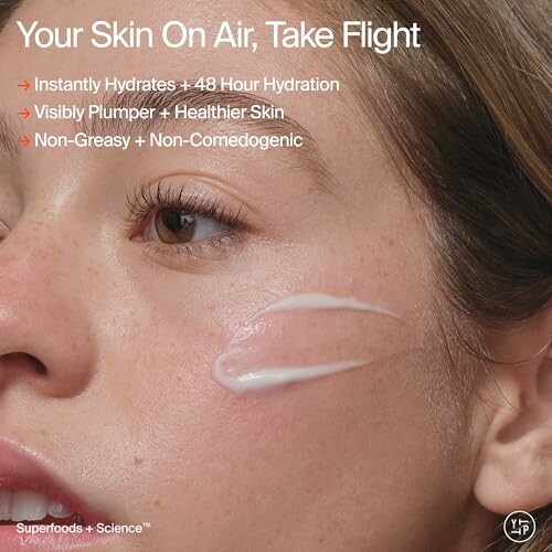 Close-up of a woman's face with skincare cream applied under her eye, promoting hydration and plump skin.