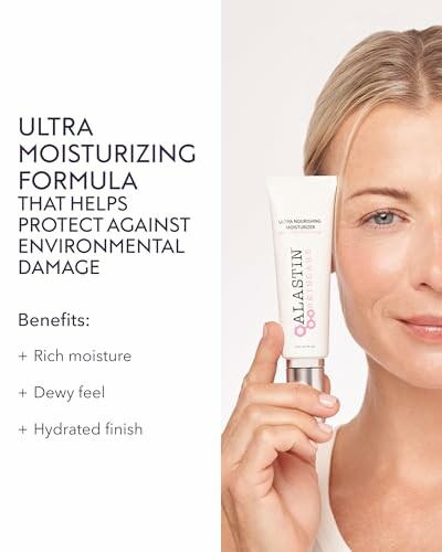 Woman holding Alastin Ultra Moisturizing formula product.