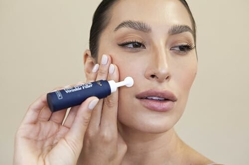 Woman applying skincare product to her face.